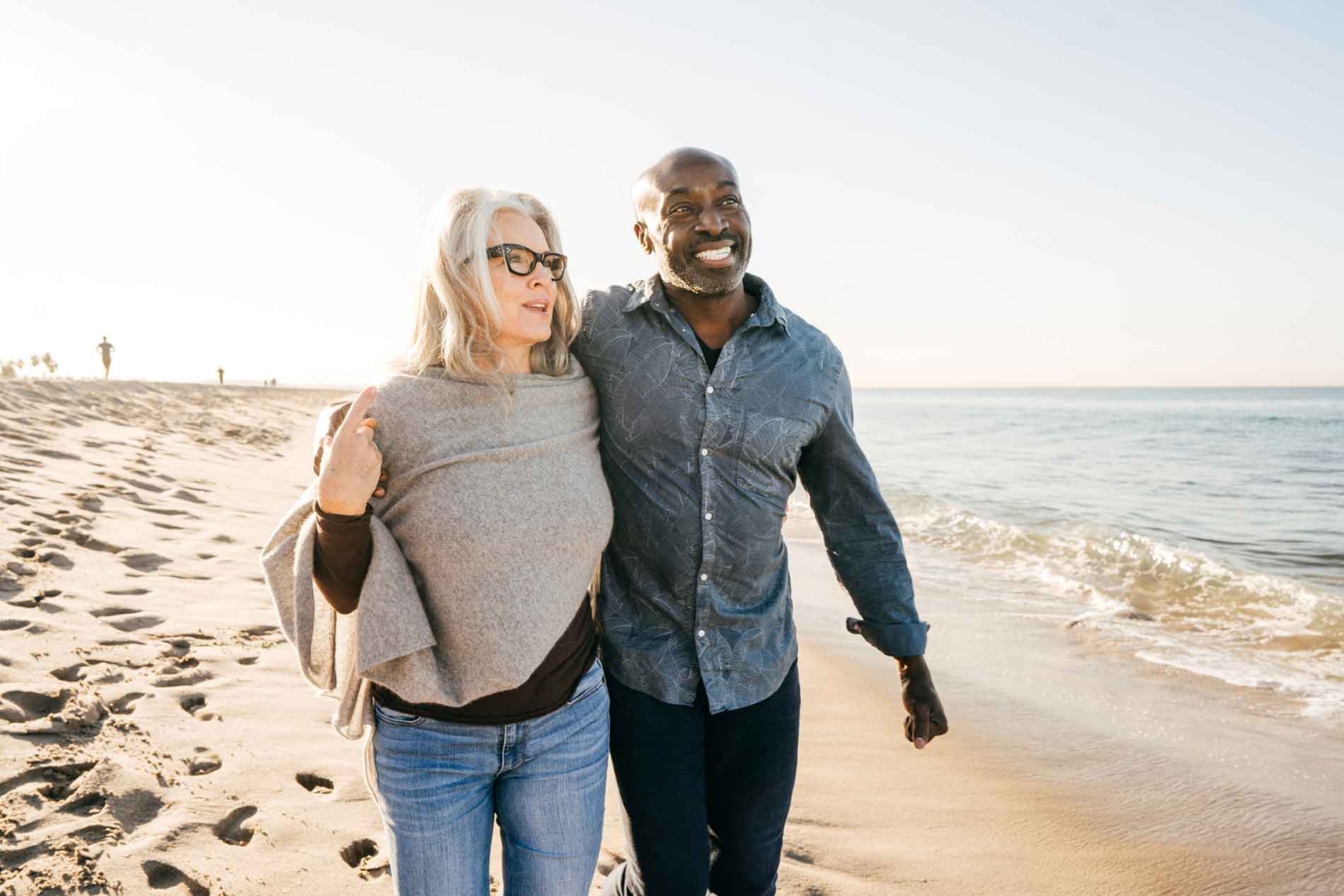 Couple walking on the beach enjoying life.