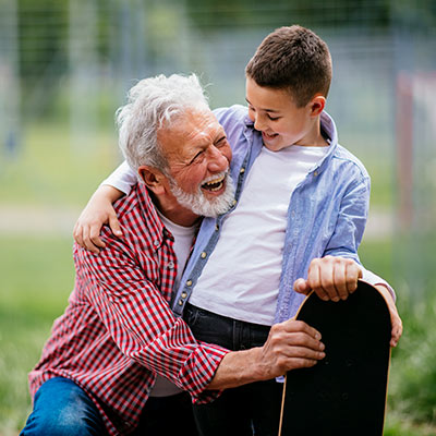 Grandpa and grandson hugging outside