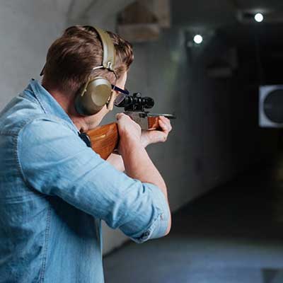 Man at shooting range wearing hearing protection.